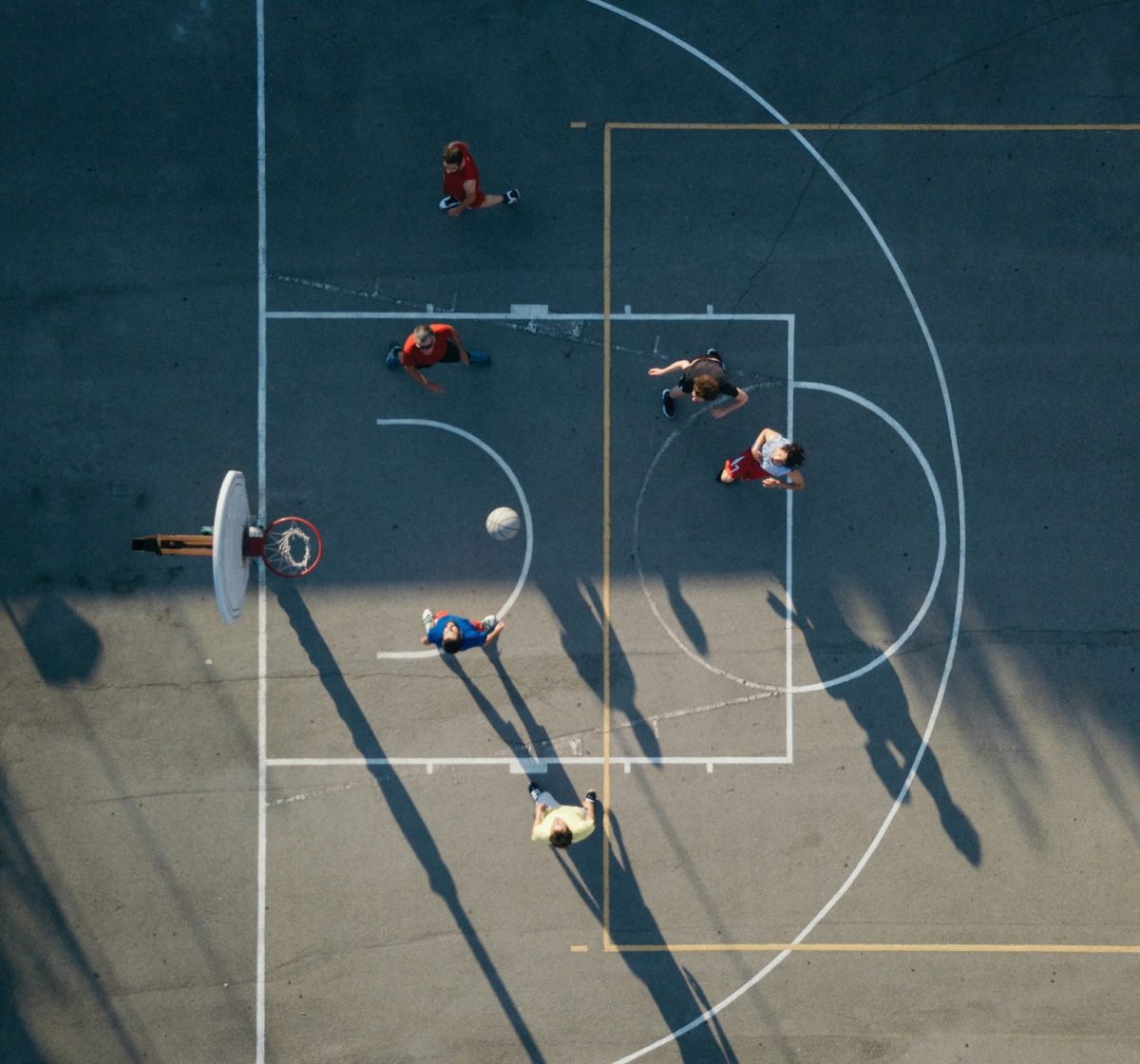 Overhead view of friends on basketball court playing basketball game
